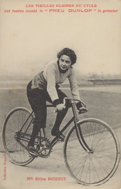 Carte postale ancienne publicitaire Dunlop : la cycliste Hélène Dutrieu (légendée « Dutrieux ») à vélo sur une piste, Camuche Dutrieu à Tournai